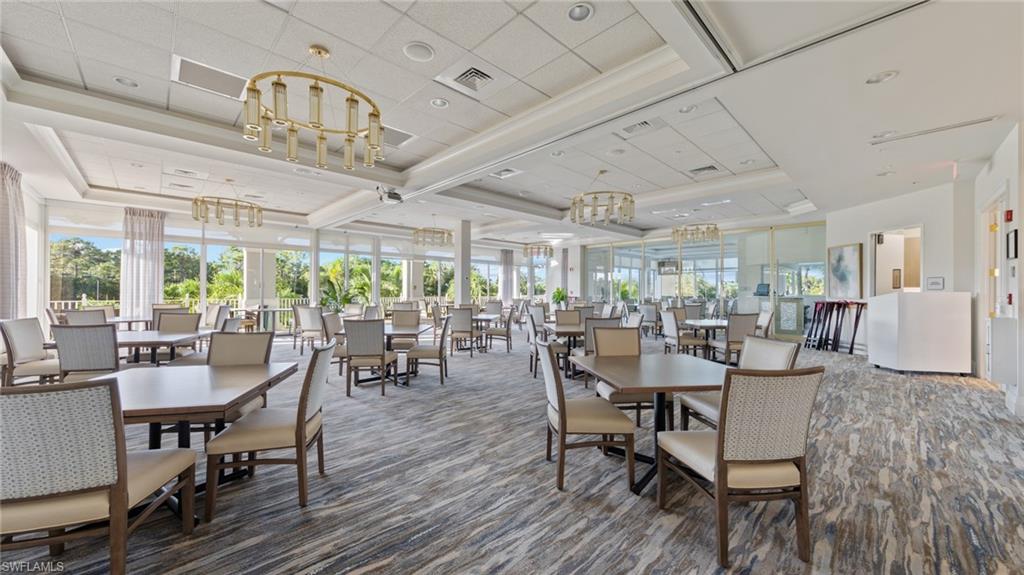 1285 Sweetwater Cove, Unit 2106 Naples, FL 34110 - Photo 29 of 38 a view of a dining room with furniture window and outside view