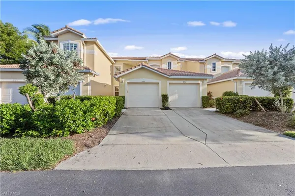 a front view of a house with a garden and plants