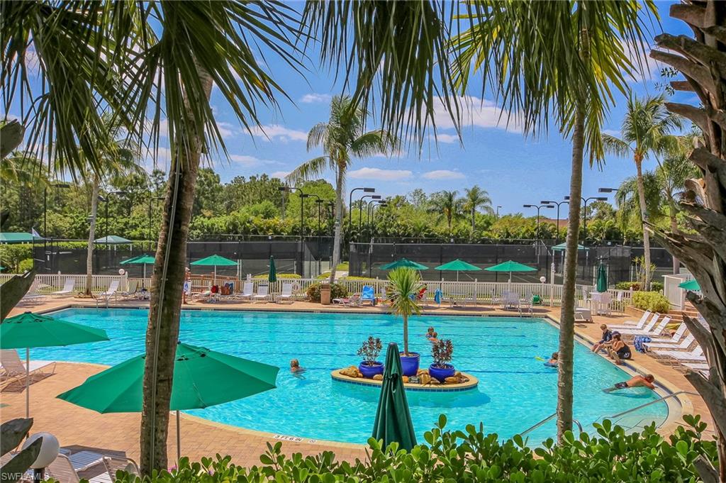 1285 Sweetwater Cove, Unit 2106 Naples, FL 34110 - Photo 33 of 38 a view of swimming pool with a table and chairs