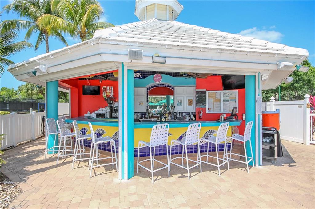 1285 Sweetwater Cove, Unit 2106 Naples, FL 34110 - Photo 34 of 38 a group of people sitting outside of a kitchen