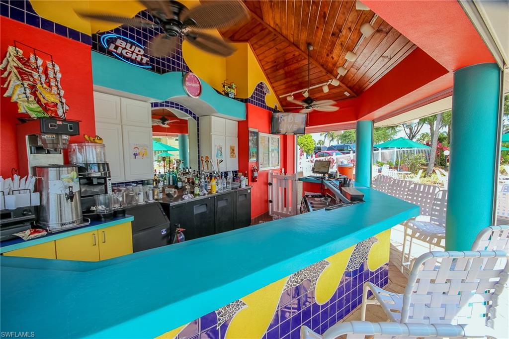 1285 Sweetwater Cove, Unit 2106 Naples, FL 34110 - Photo 35 of 38 an outdoor space with swimming pool and furniture