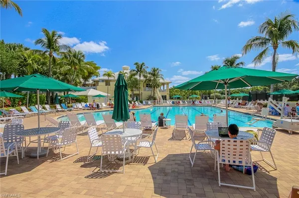 an outdoor space with swimming pool and furniture