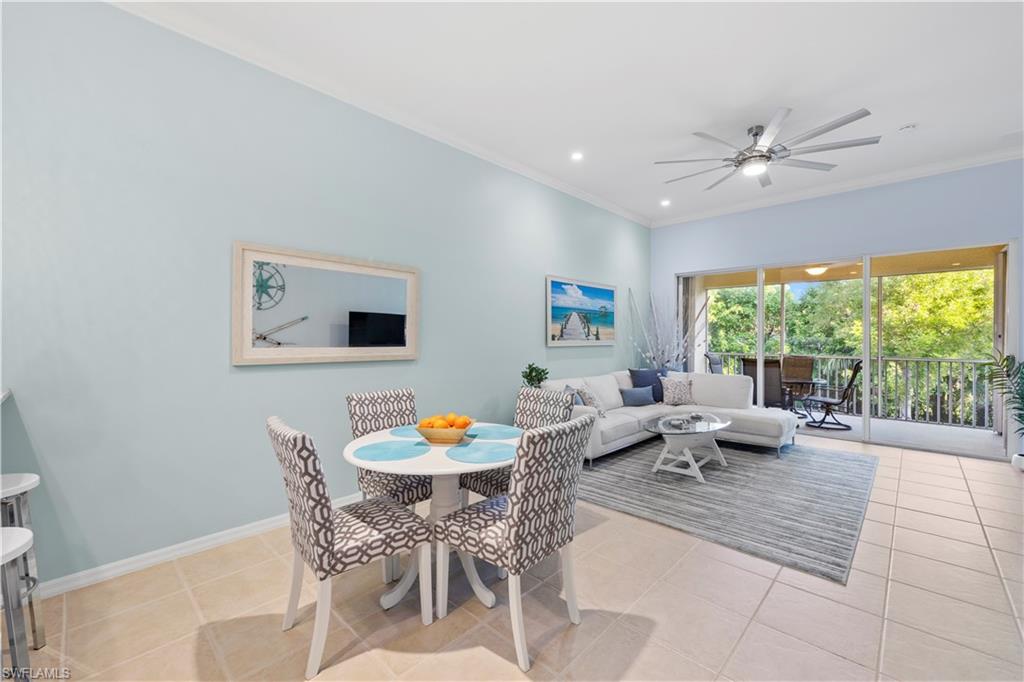 1285 Sweetwater Cove, Unit 2106 Naples, FL 34110 - Photo 7 of 38 a living room with furniture and a large window