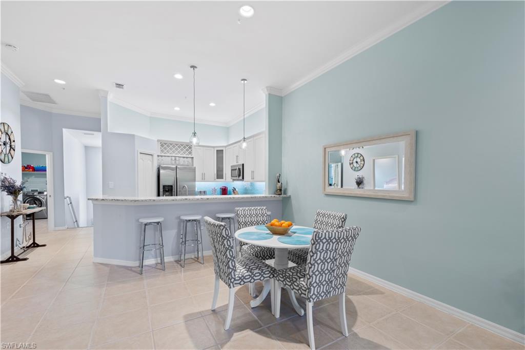 1285 Sweetwater Cove, Unit 2106 Naples, FL 34110 - Photo 8 of 38 a dining room with furniture and window
