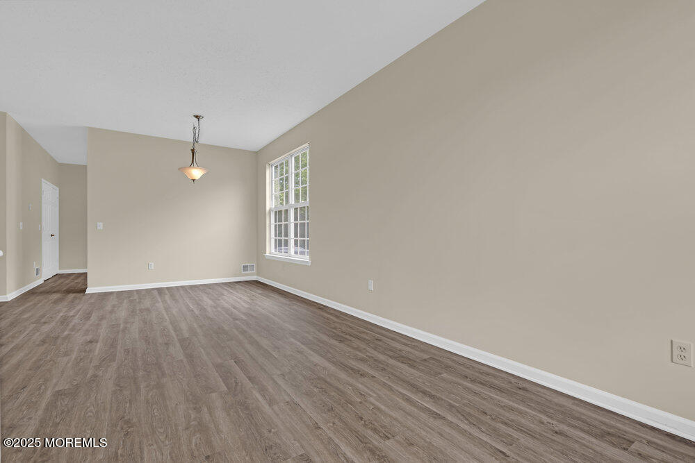 80 Quail Road Barnegat, NJ 08005 - Photo 13 of 27 an empty room with wooden floor and windows