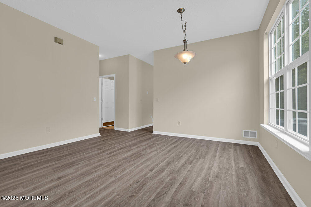80 Quail Road Barnegat, NJ 08005 - Photo 14 of 27 wooden floor in an empty room with a window