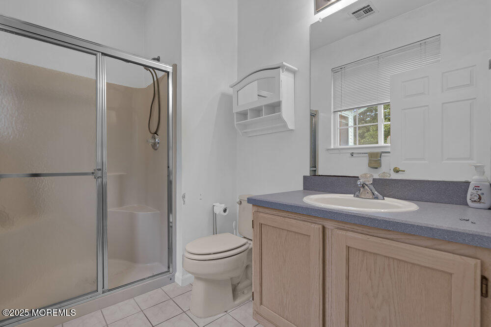 80 Quail Road Barnegat, NJ 08005 - Photo 17 of 27 a bathroom with a granite countertop sink toilet and shower