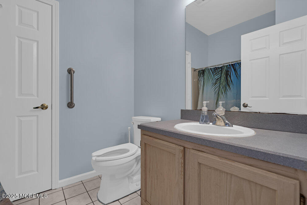 80 Quail Road Barnegat, NJ 08005 - Photo 21 of 27 a bathroom with a granite countertop sink a toilet and a mirror