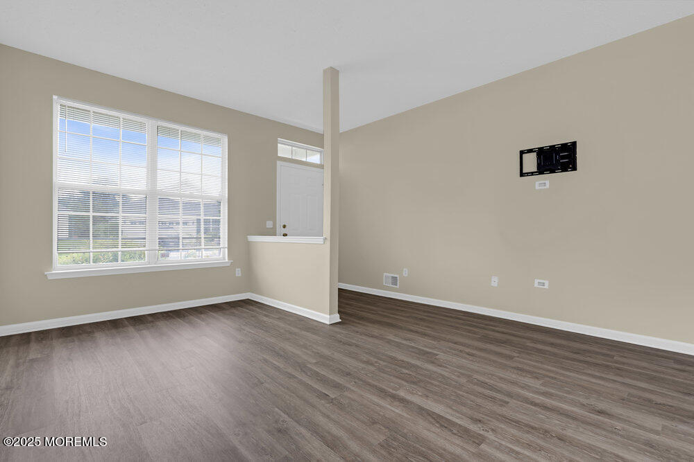 80 Quail Road Barnegat, NJ 08005 - Photo 3 of 27 a view of an empty room with wooden floor and a window