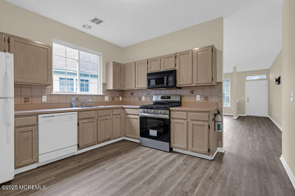 80 Quail Road Barnegat, NJ 08005 - Photo 6 of 27 a kitchen with a sink a window and stainless steel appliances