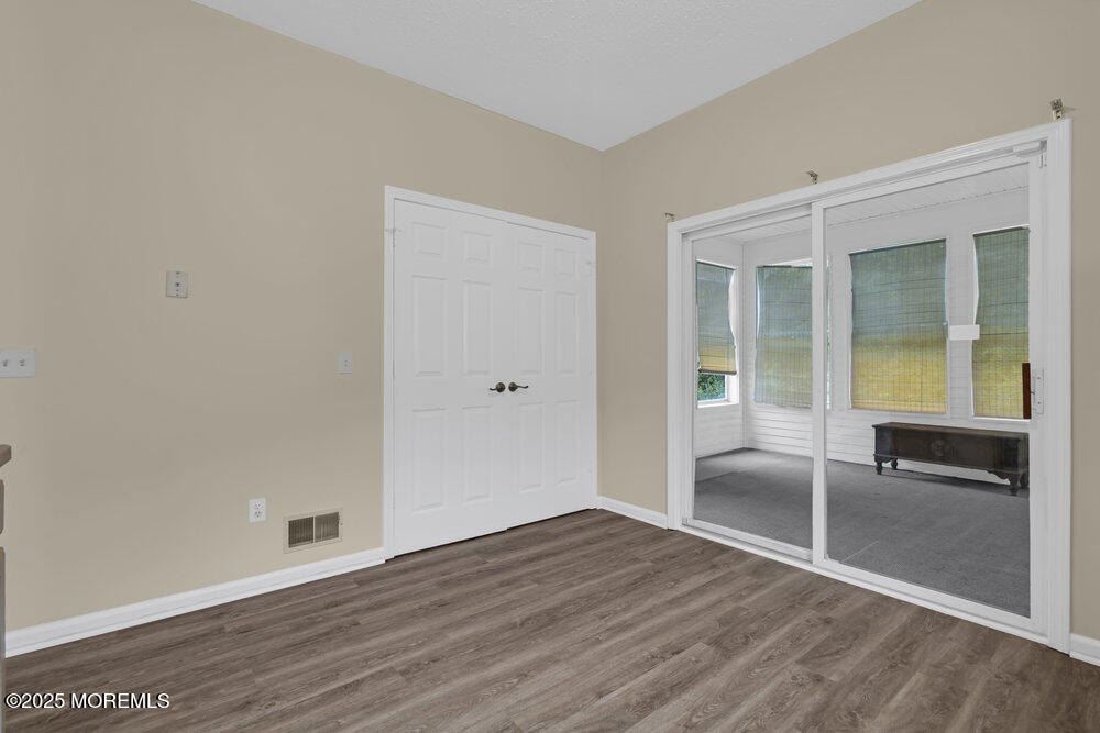 80 Quail Road Barnegat, NJ 08005 - Photo 8 of 27 an empty room with wooden floor and windows