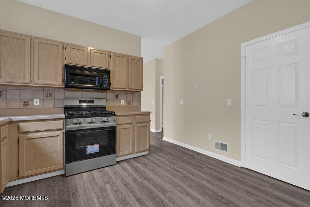80 Quail Road Barnegat, NJ 08005 - Photo 9 of 27 a kitchen with granite countertop a refrigerator stove and microwave