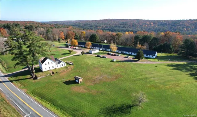 a view of a golf course with chairs and a yard