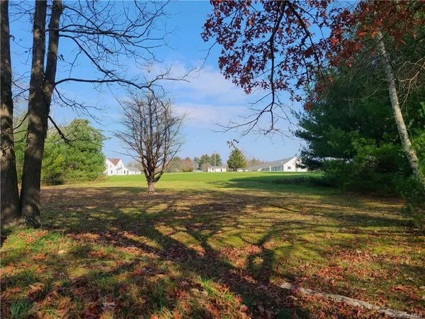 a view of a lake with houses in the background