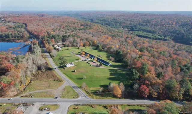 an aerial view of a house with a yard