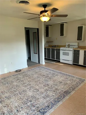 a living room with furniture a flat screen tv and a table