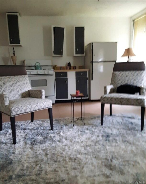 22 Arrowhead Apartments Road Narrowsburg, NY 12764 - Photo 22 of 34 a living room with furniture a flat screen tv and a table