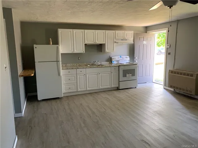 a kitchen with stainless steel appliances granite countertop a stove and a sink