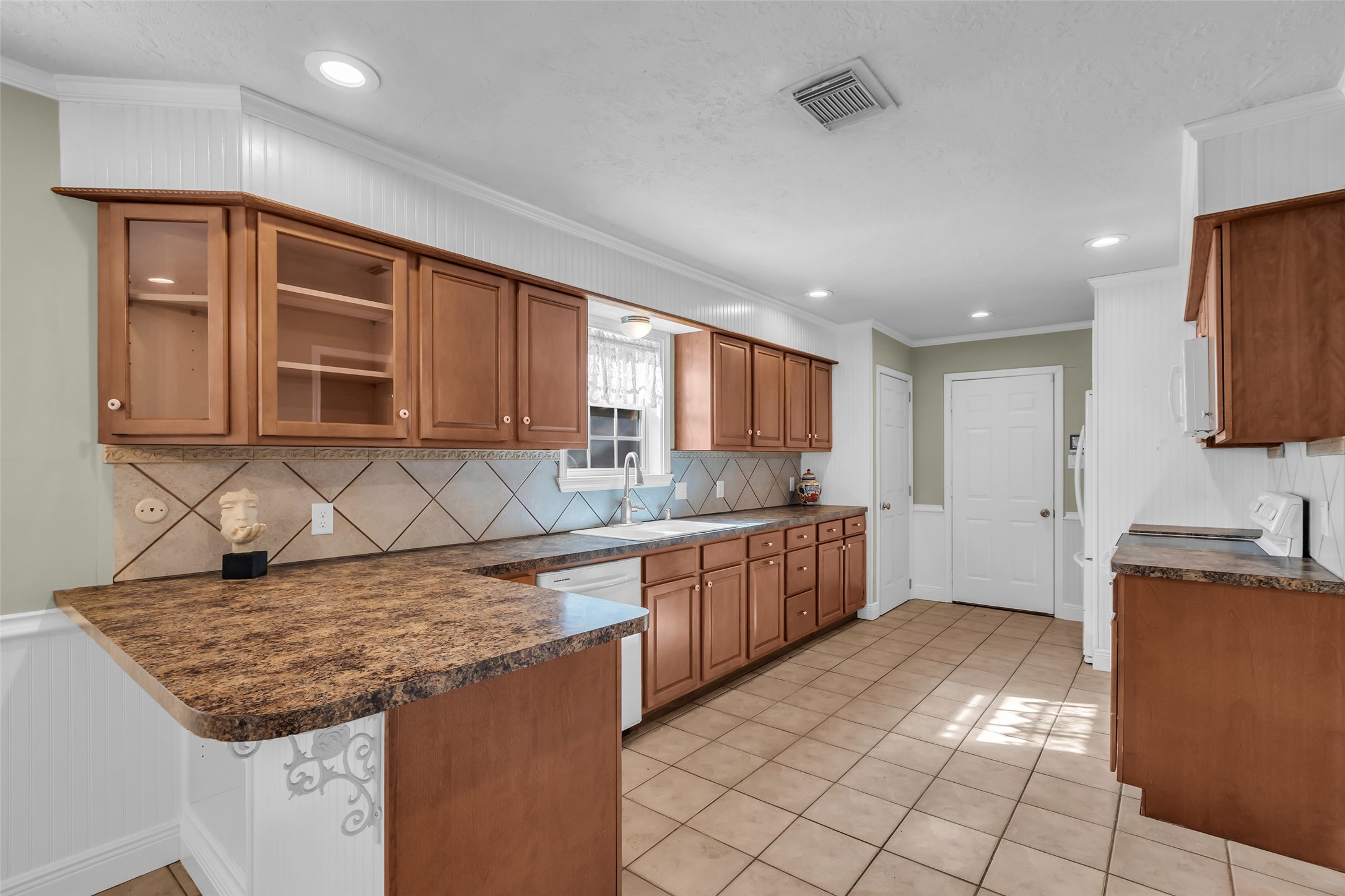 23826 Farm Hill Drive Spring, TX 77373 - Photo 11 of 38 a kitchen with granite countertop a sink stove and cabinets
