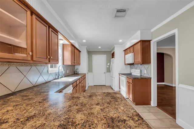 a kitchen with a refrigerator sink and microwave