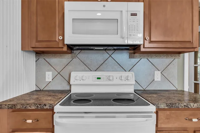 a stove top oven sitting inside of a kitchen