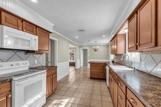 a kitchen with stainless steel appliances granite countertop a sink stove and cabinets