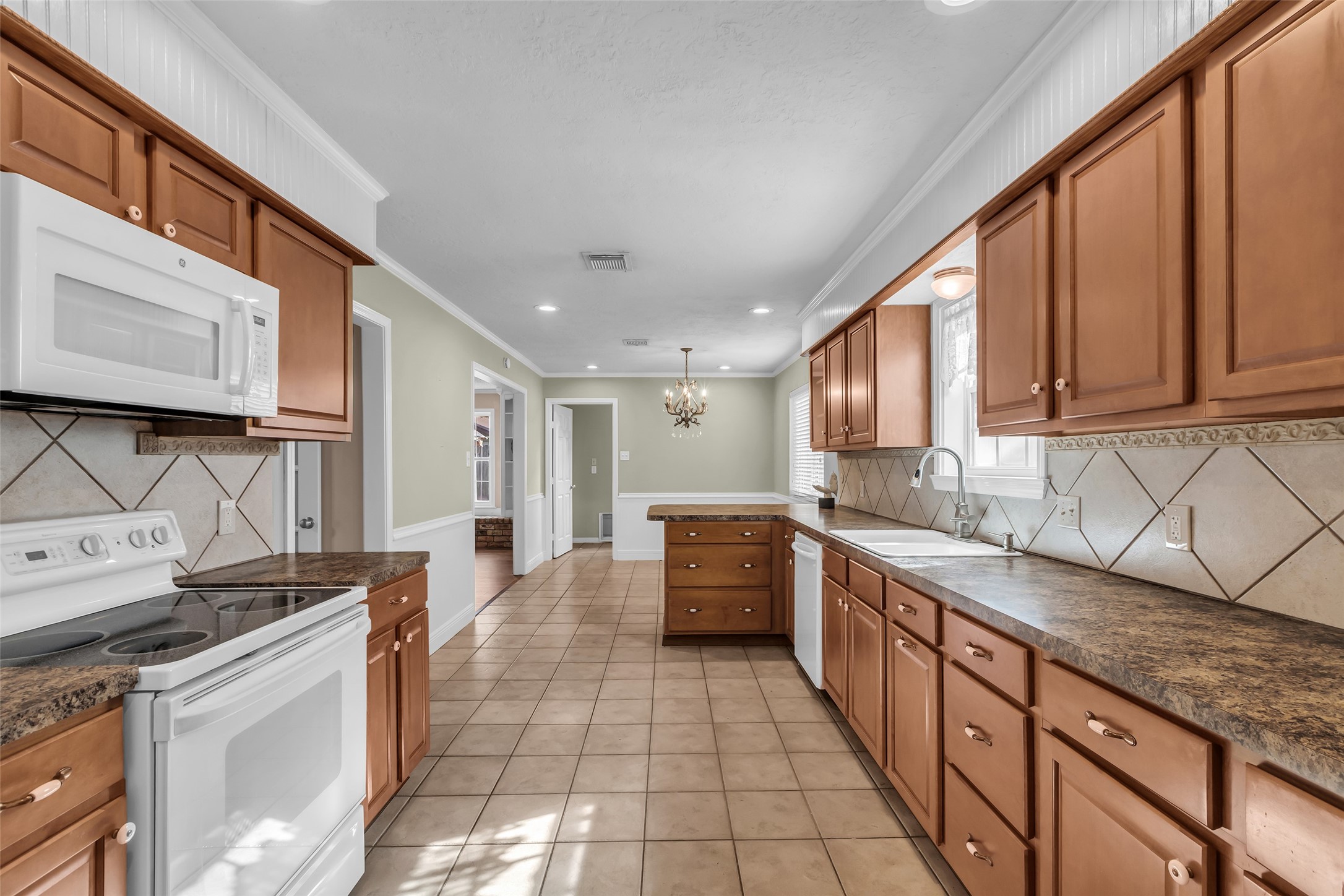 23826 Farm Hill Drive Spring, TX 77373 - Photo 18 of 38 a large kitchen with stainless steel appliances granite countertop a sink and cabinets