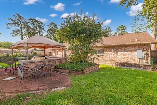 a view of a house with backyard porch and sitting area