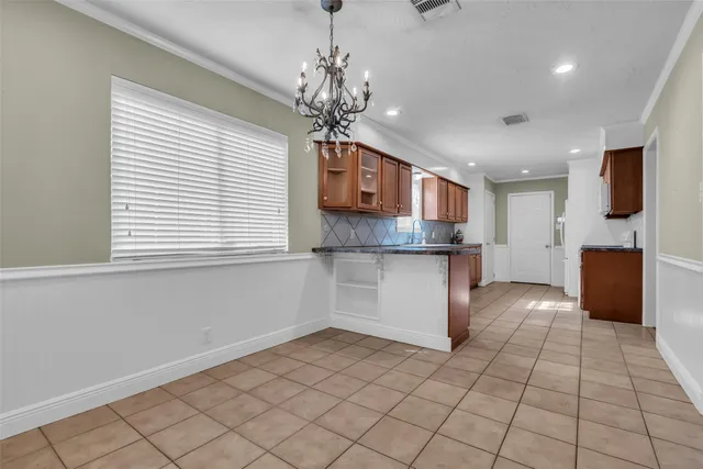 a kitchen with kitchen island granite countertop a stove a sink and a refrigerator