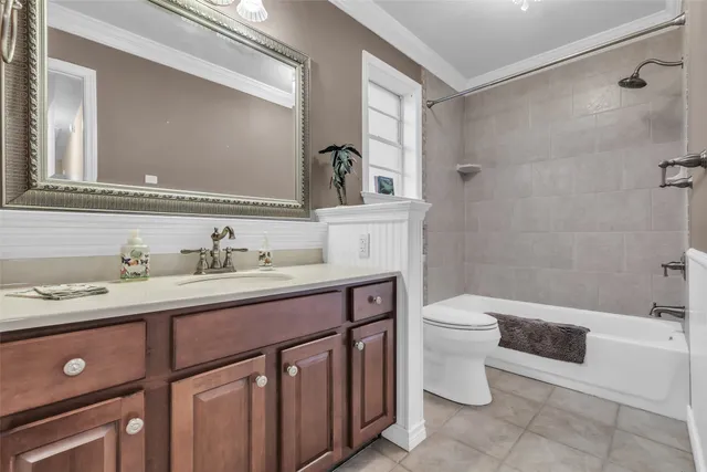 a bathroom with a toilet a sink a mirror a bathtub and vanity