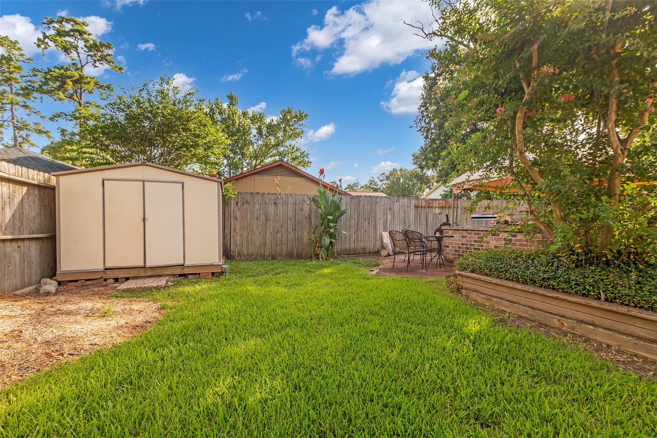 23826 Farm Hill Drive Spring, TX 77373 - Photo 37 of 38 a backyard of a house with table and chairs and a large tree