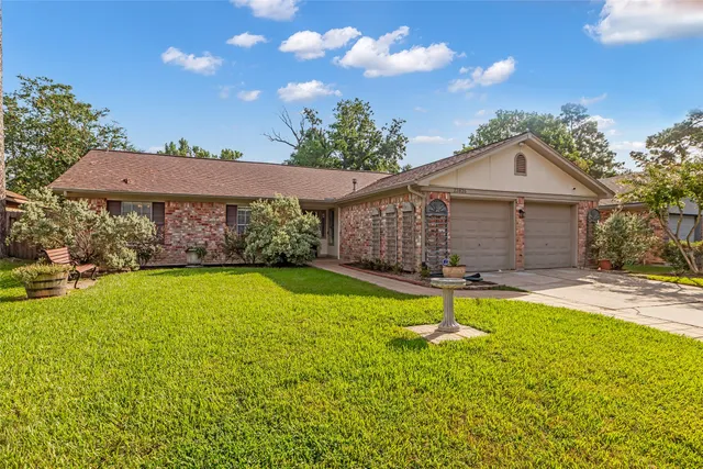 a front view of a house with a yard and swimming pool