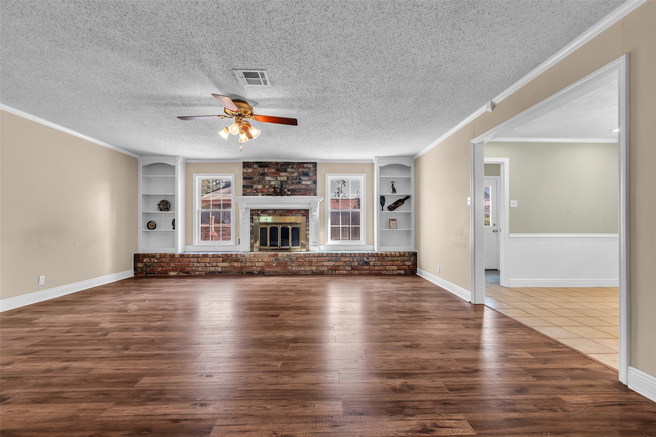 23826 Farm Hill Drive Spring, TX 77373 - Photo 5 of 38 an empty room with wooden floor fireplace and a window