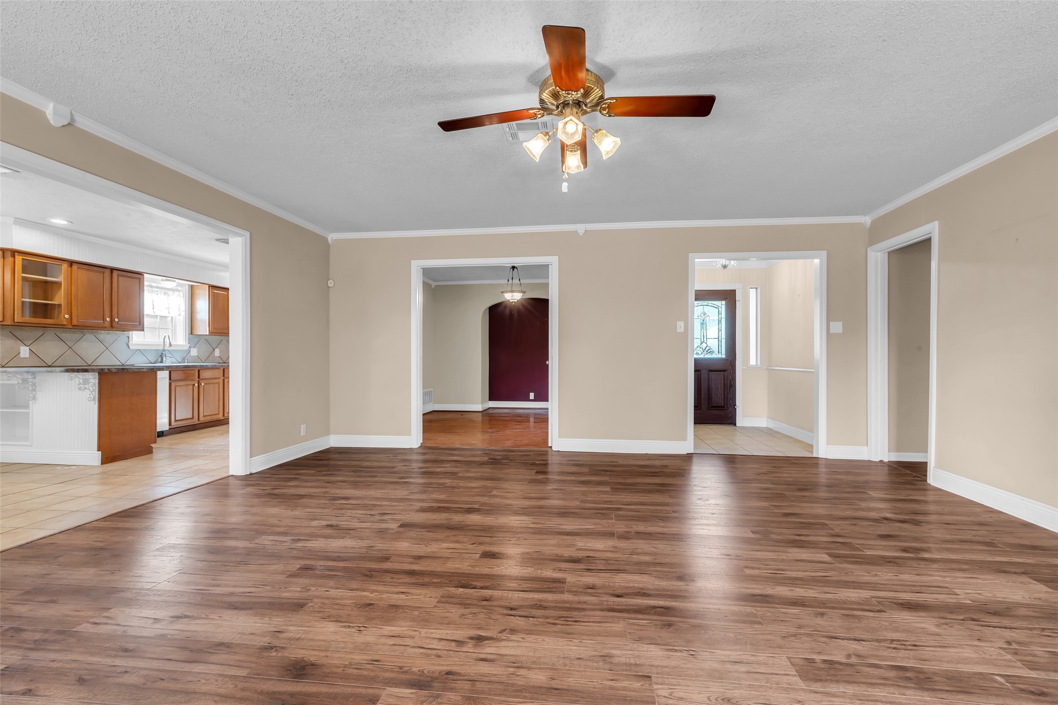 23826 Farm Hill Drive Spring, TX 77373 - Photo 8 of 38 a view of an empty room with wooden floor and a kitchen