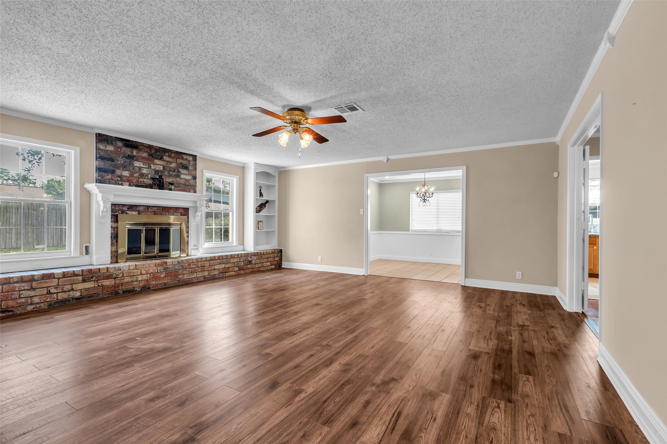 23826 Farm Hill Drive Spring, TX 77373 - Photo 10 of 38 an empty room with wooden floor fireplace and windows