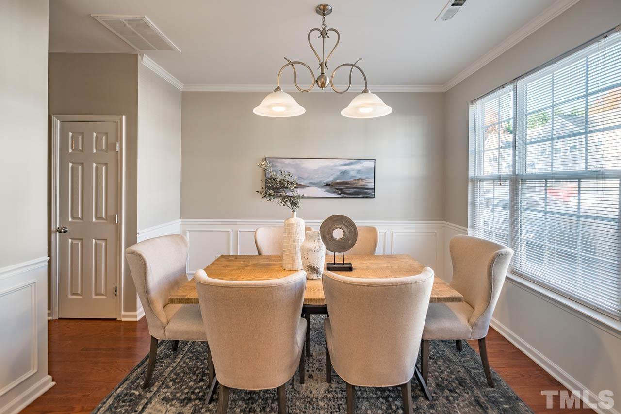 8453 Reedy Ridge Lane Raleigh, NC 27613 - Photo 2 of 21 a dining room with furniture a window and wooden floor