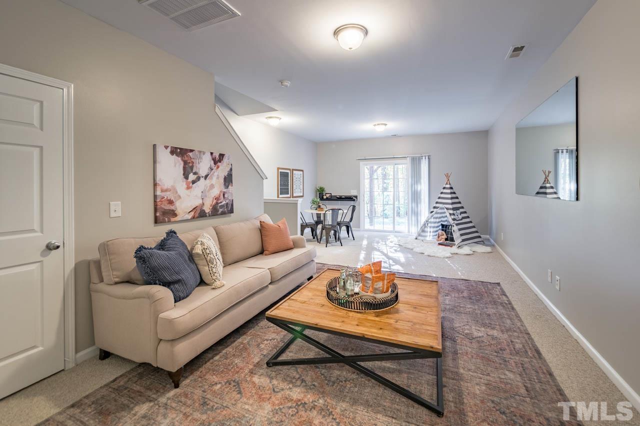 8453 Reedy Ridge Lane Raleigh, NC 27613 - Photo 16 of 21 a living room with furniture and wooden floor