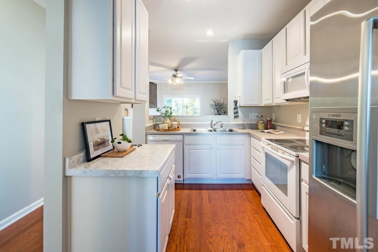 8453 Reedy Ridge Lane Raleigh, NC 27613 - Photo 3 of 21 a kitchen with a sink stove and refrigerator