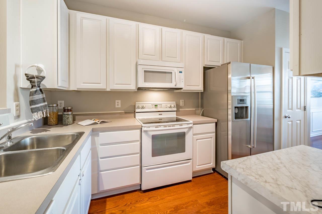 8453 Reedy Ridge Lane Raleigh, NC 27613 - Photo 5 of 21 a kitchen with a sink stove and refrigerator