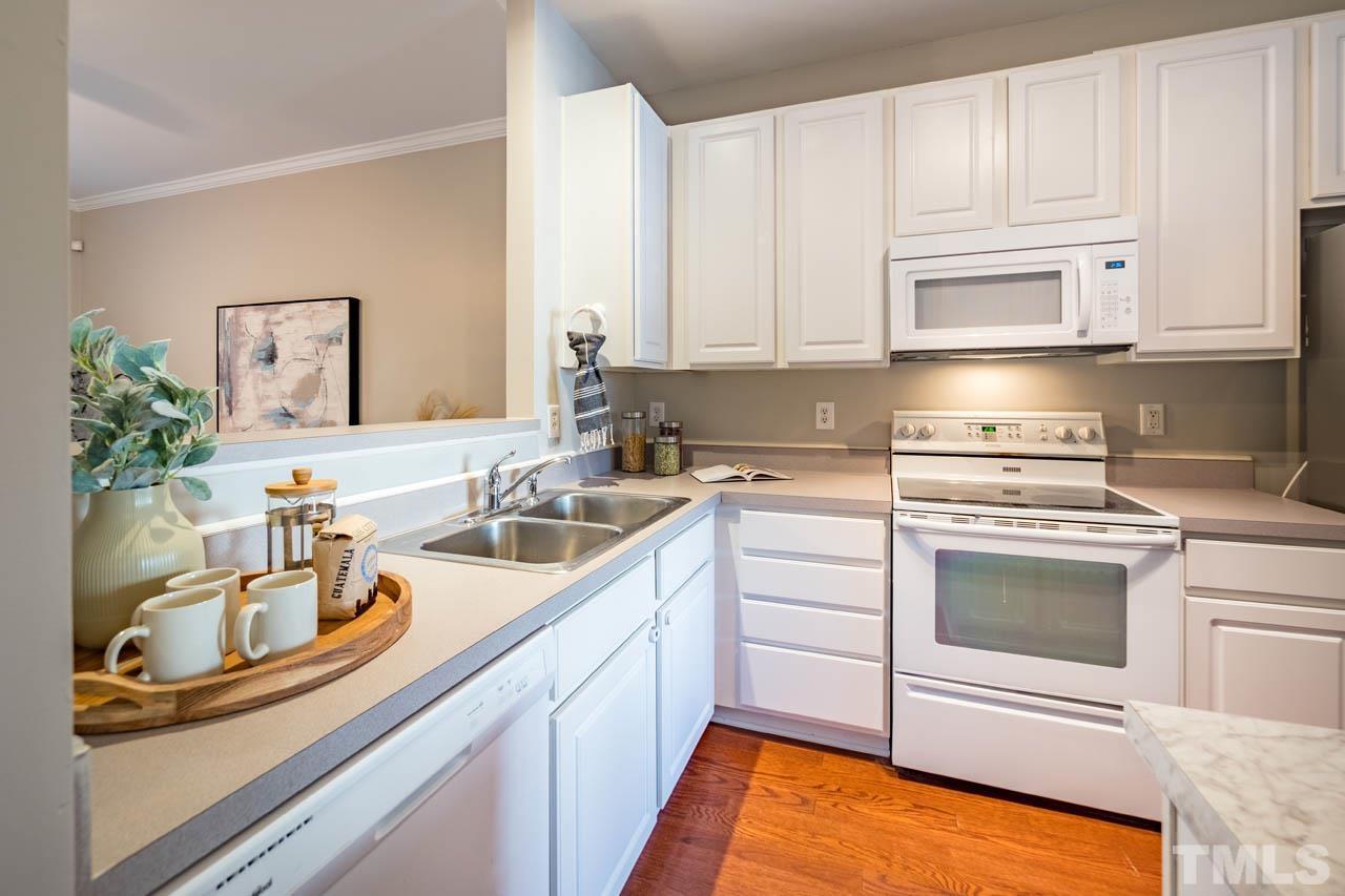 8453 Reedy Ridge Lane Raleigh, NC 27613 - Photo 6 of 21 a kitchen with stainless steel appliances granite countertop a sink and cabinets