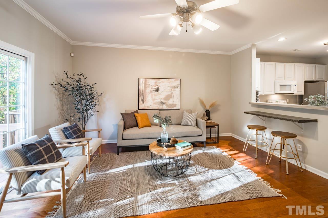 8453 Reedy Ridge Lane Raleigh, NC 27613 - Photo 8 of 21 a living room with furniture wooden floor and a chandelier