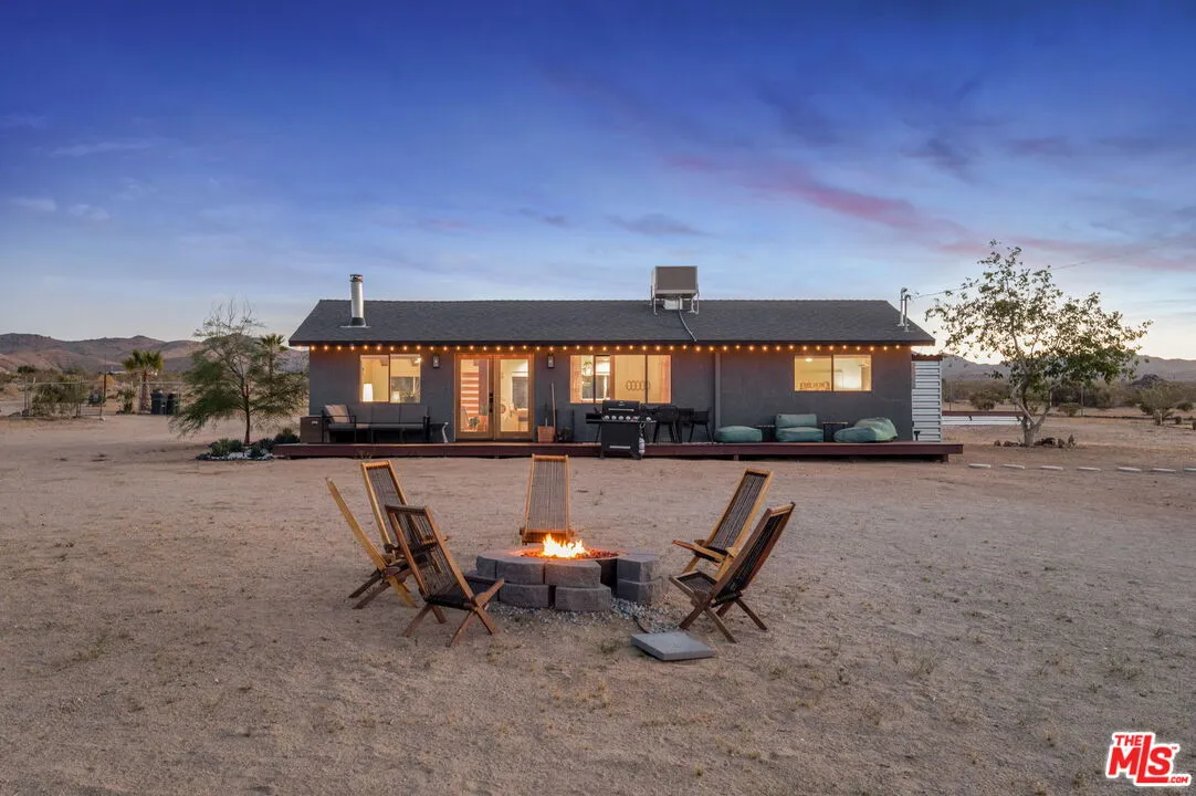 a view of a house with backyard porch and sitting area