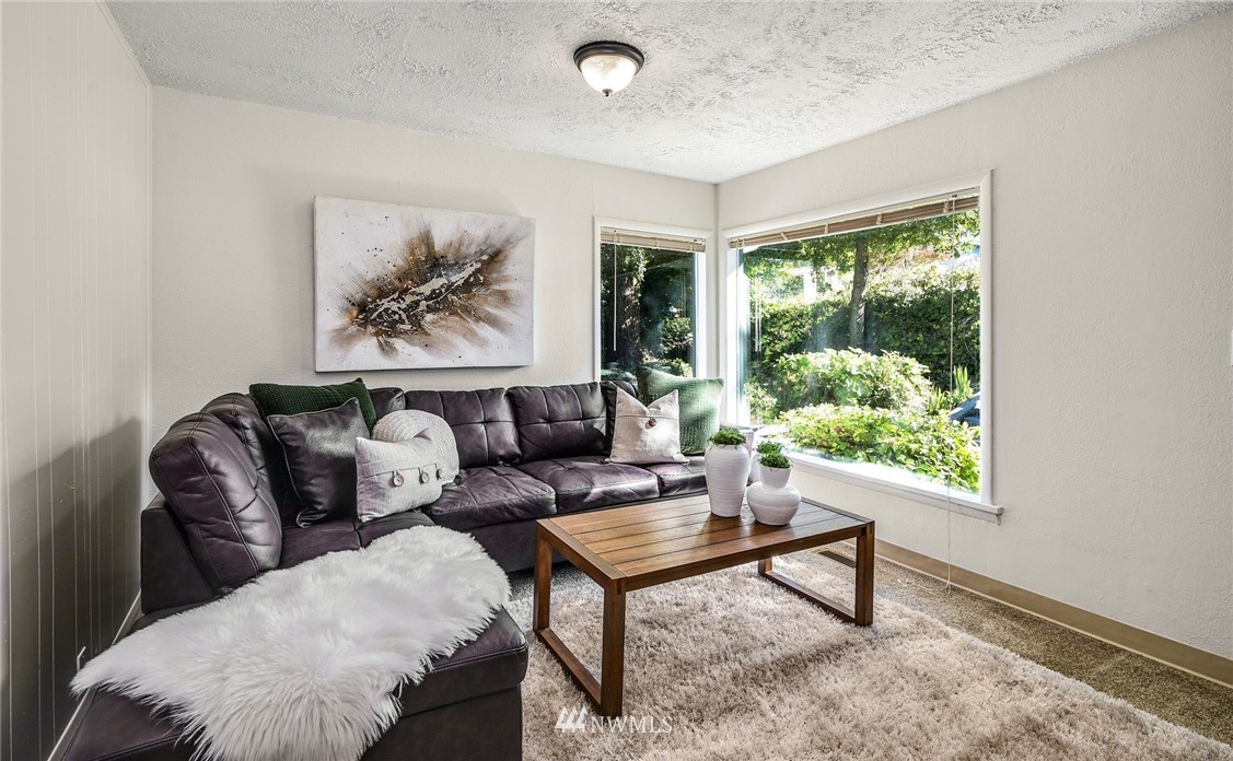 7511 14th Avenue Southwest Seattle, WA 98106 - Photo 2 of 16 a living room with furniture and a window
