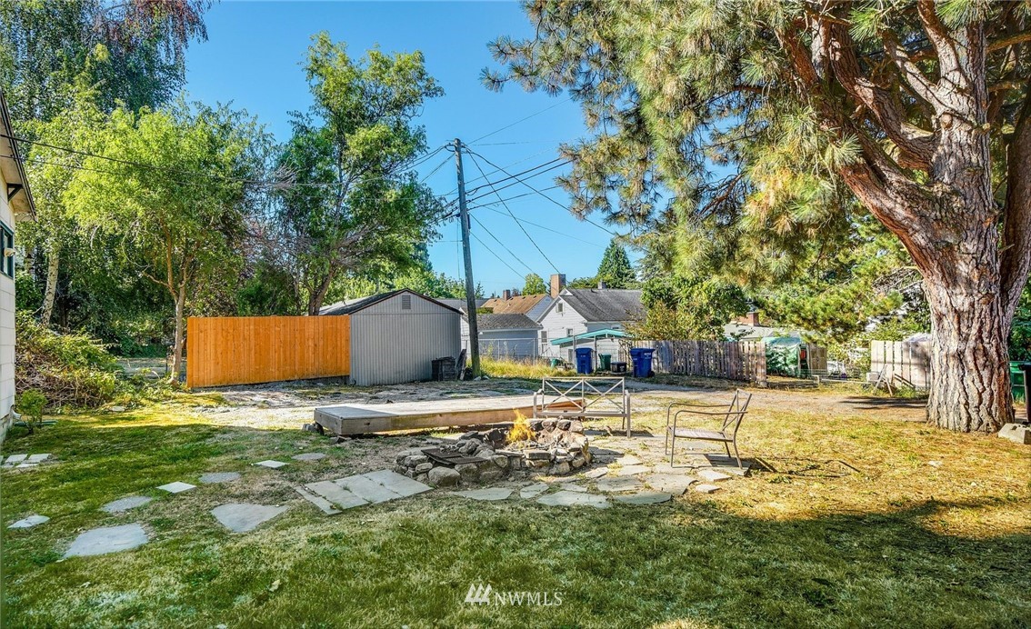 7511 14th Avenue Southwest Seattle, WA 98106 - Photo 12 of 16 a backyard of a house with table and chairs