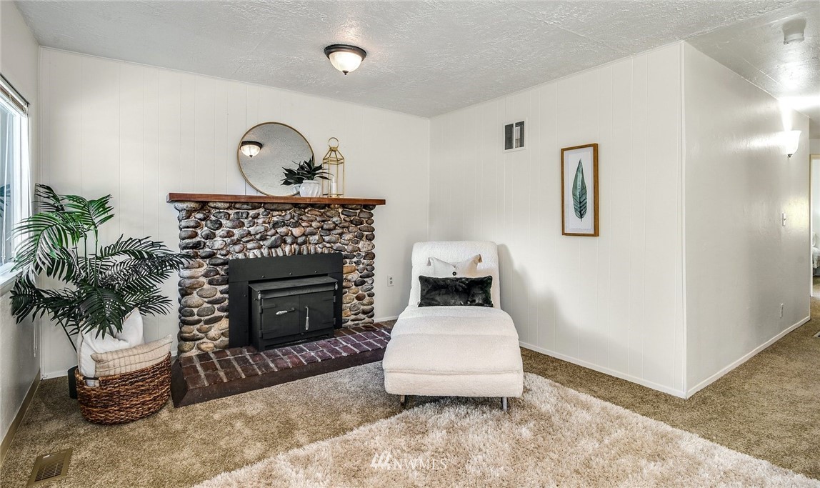 7511 14th Avenue Southwest Seattle, WA 98106 - Photo 3 of 16 a living room with furniture and a fireplace