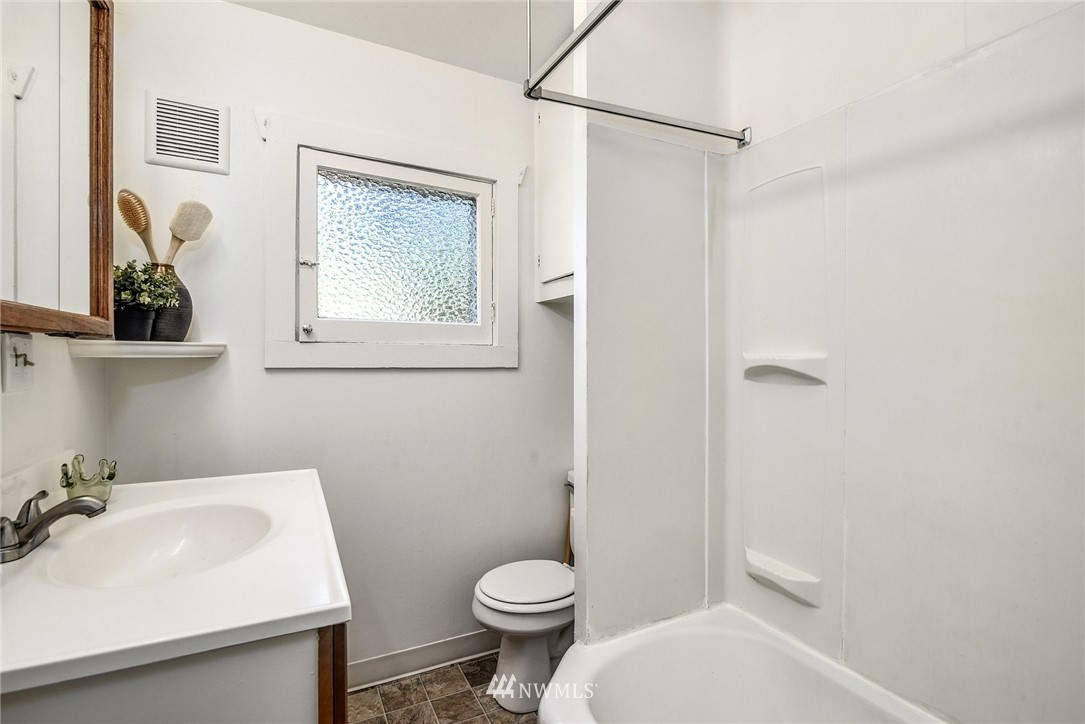 7511 14th Avenue Southwest Seattle, WA 98106 - Photo 10 of 16 a bathroom with a sink toilet and mirror