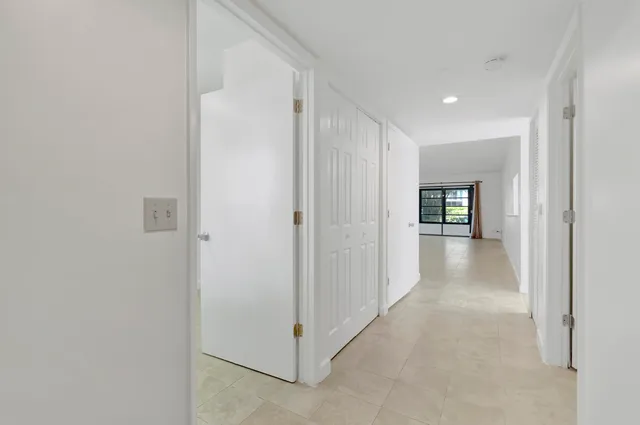 a view of a hallway with wooden shelves