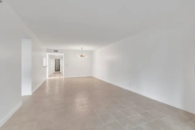 a view of a big room with closet and windows