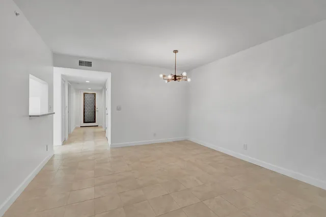 a kitchen with granite countertop white cabinets sink and stainless steel appliances