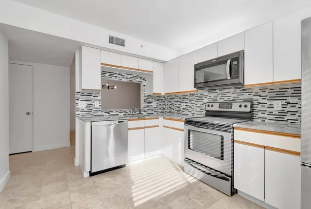 an empty room with windows and closet